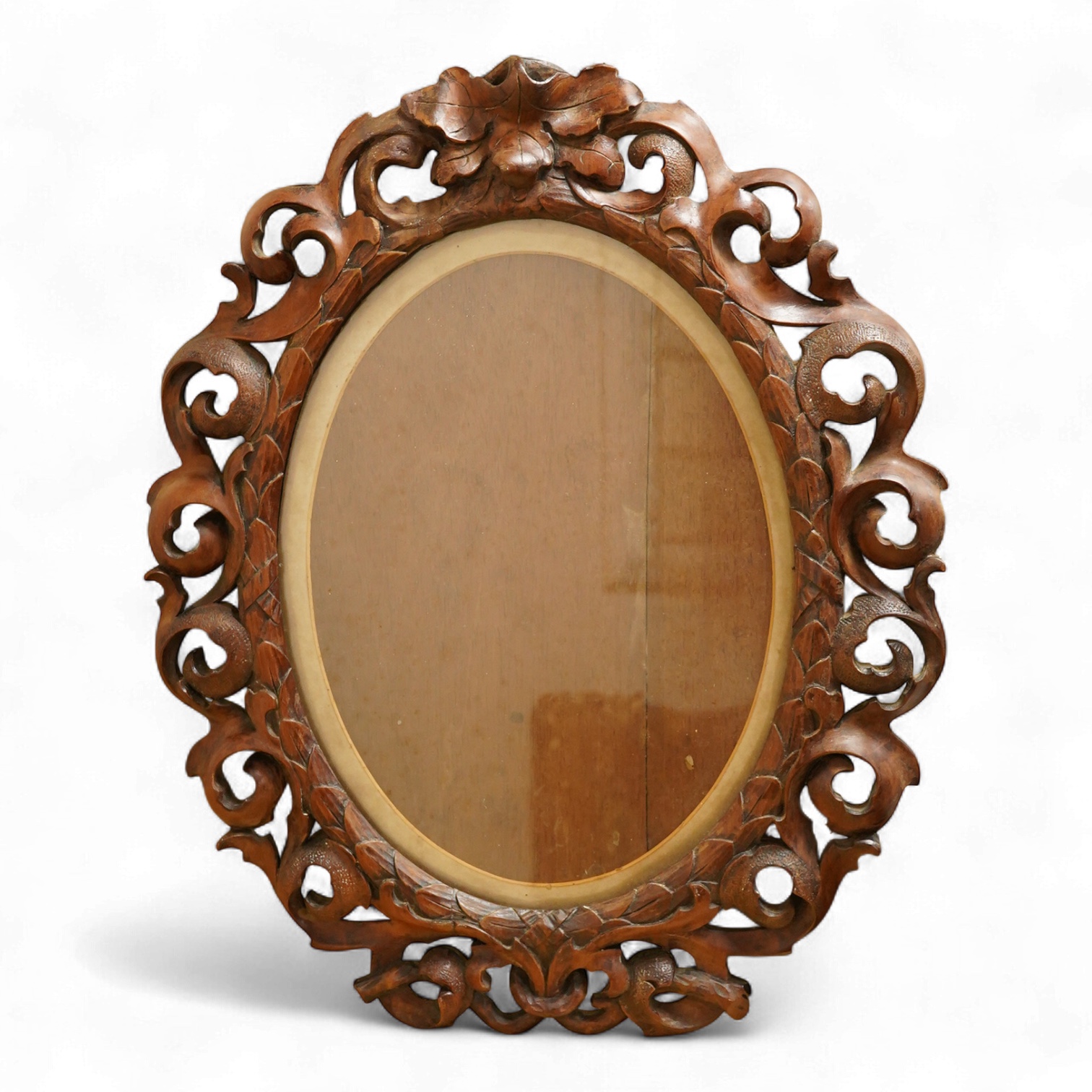An oval carved wood mirror, 53cm high